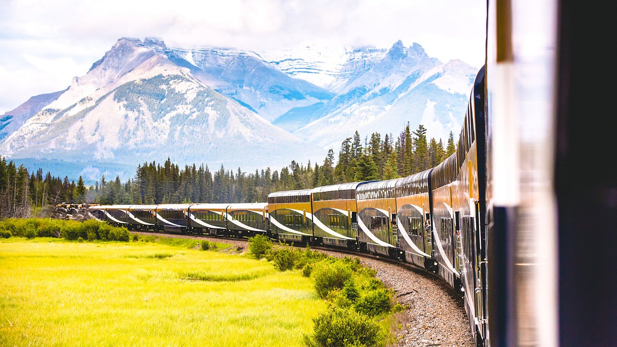 Luxury train moving through mountain passes in the Canadian Rockies